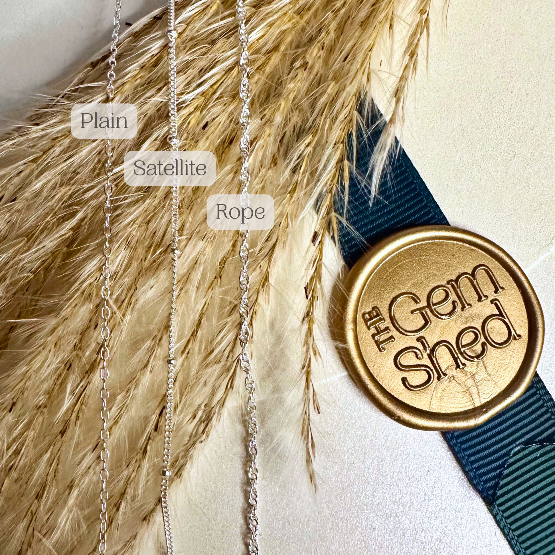 Three types of necklaces labeled 'Plain', 'Satellite', and 'Rope' with a gold 'The Gem Shed' stamp on a textured surface.